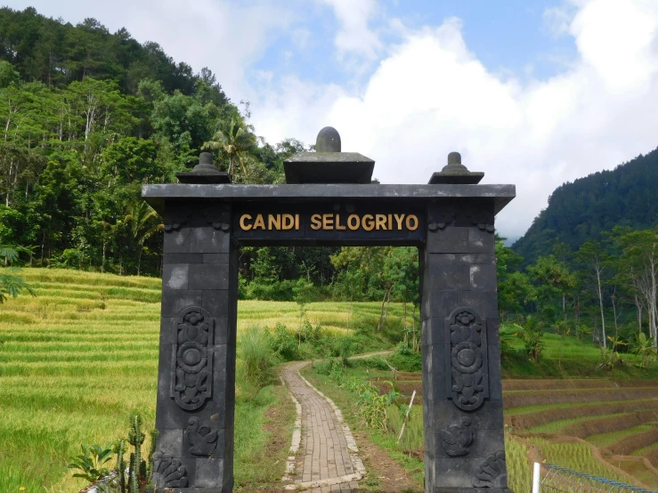 the gate to a field on a side walk