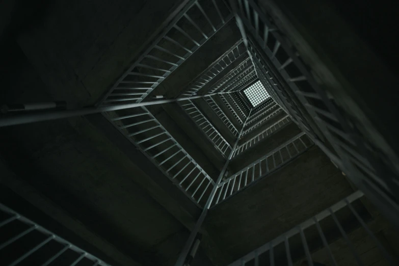 inside the dark cage stairs is an open door