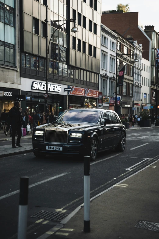 a car on a city street with some people in the background