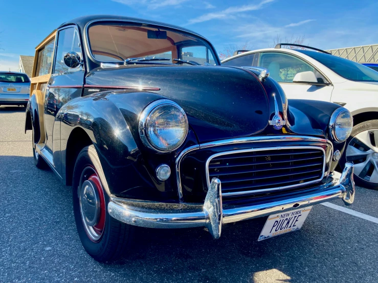 an old vintage black car in a parking lot