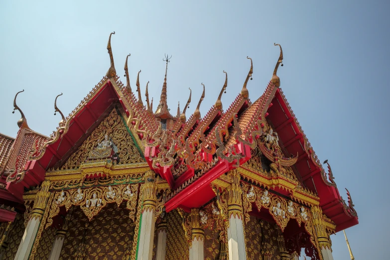 the top part of an elaborately decorated building with ornate carvings