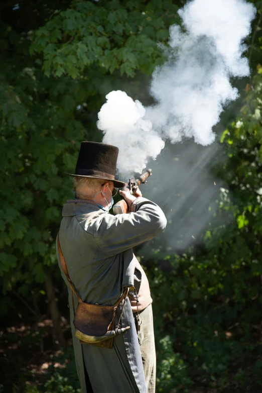 a man with a top hat shooting a rifle