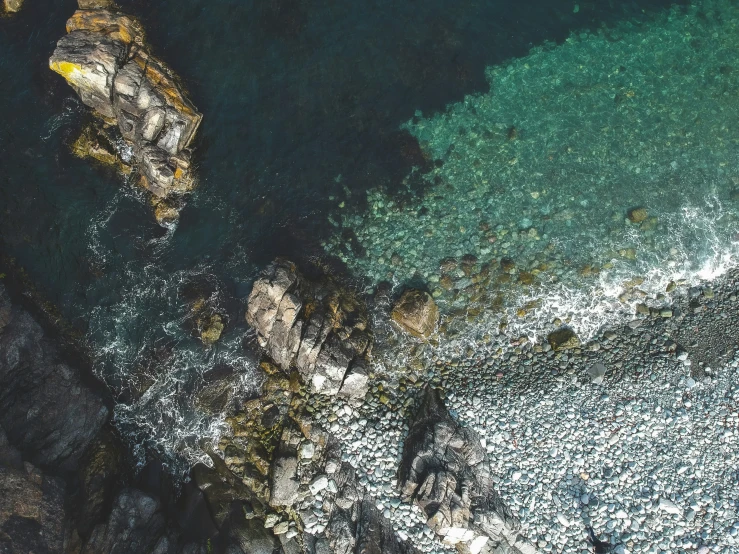 an aerial view of a group of boats at sea shore