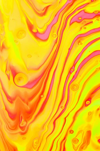 yellow and purple swirls of liquid are flowing together