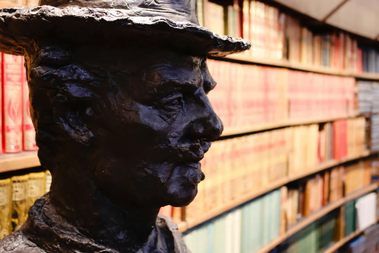 the bronze statue has many books on it's shelves
