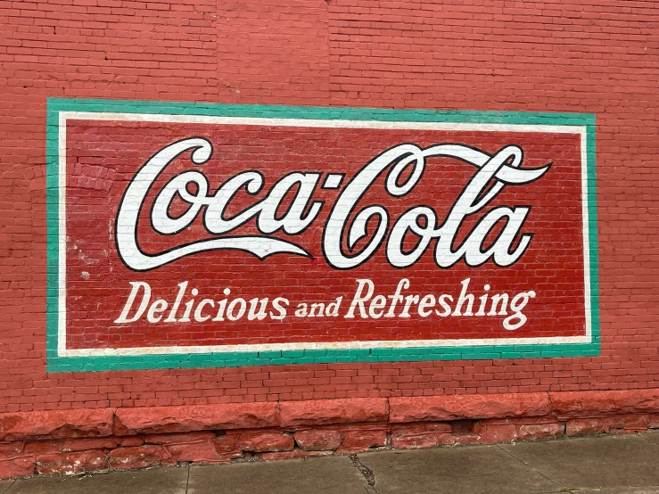a coca cola sign on the side of a building