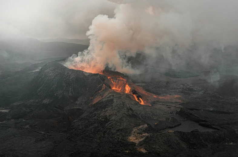 an aerial view of a huge mountain with lots of smoke and smoke