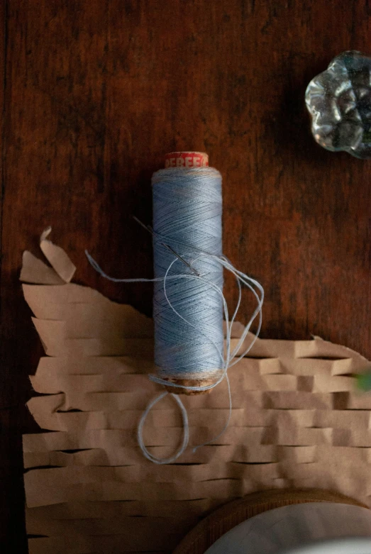 a close up of a spool of thread on a table