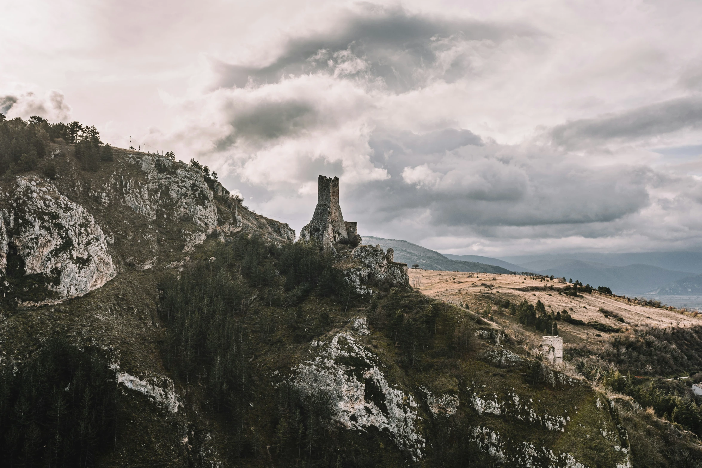 a stone tower that is on a hill