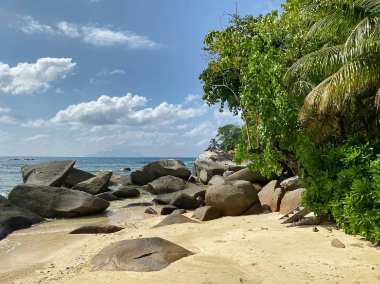 an ocean shore with large rocks and water