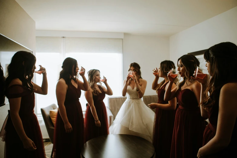 a bride is looking at her dress while getting ready for her wedding