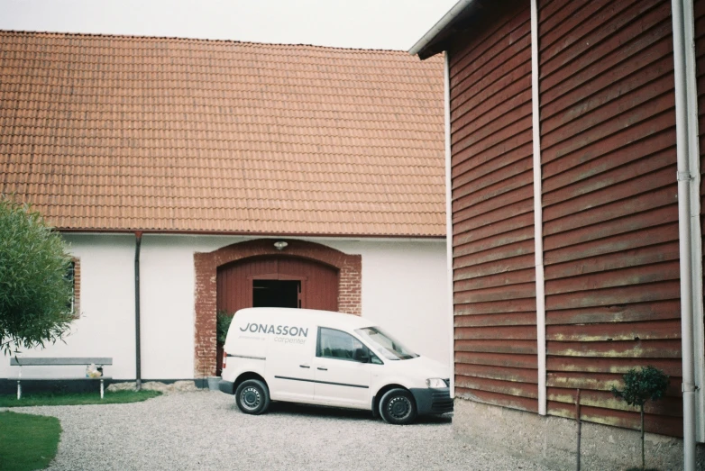 a white van parked in front of a building