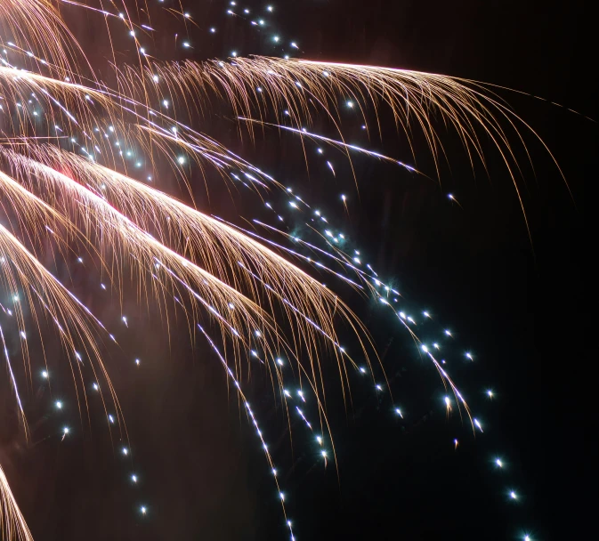 large colorful fireworks are being lit up at night time