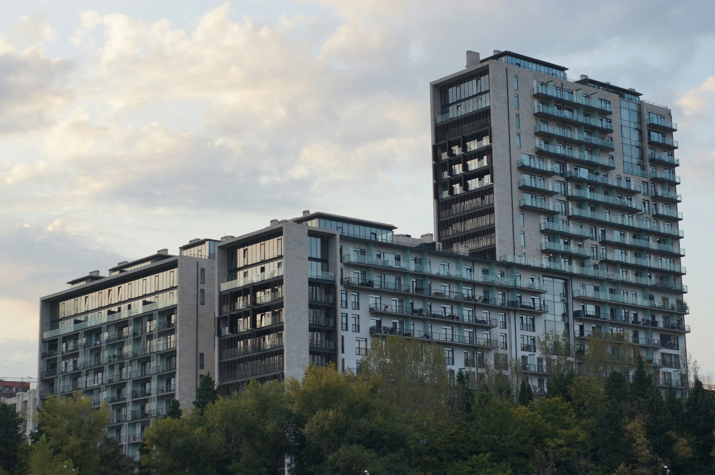 two high rise buildings with trees surrounding