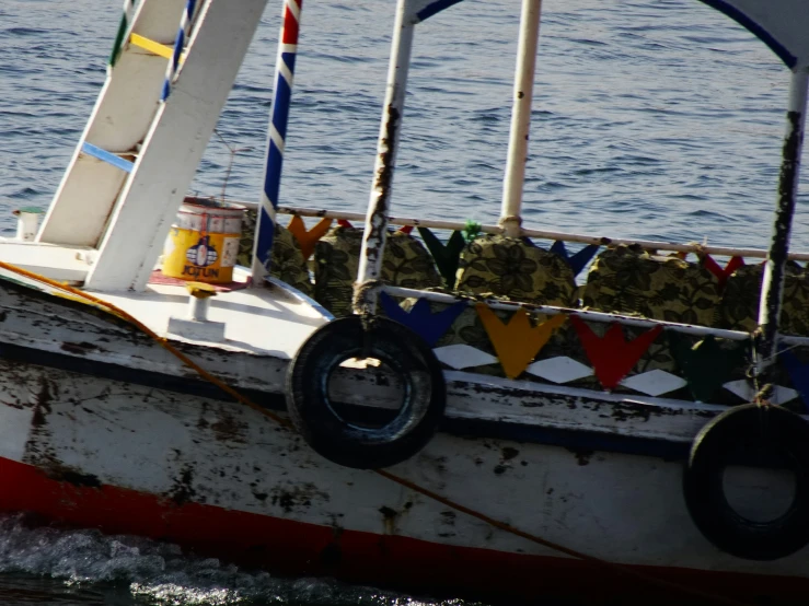 a old sail boat with a patchwork covering is seen