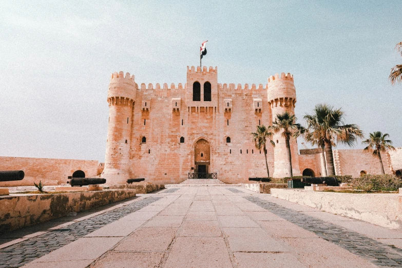 a castle sitting on top of a desert covered hillside