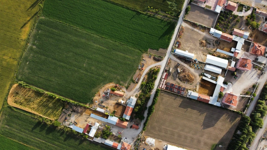 a very large field with some farm land in front