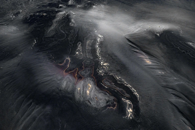 a black and white image of clouds over water