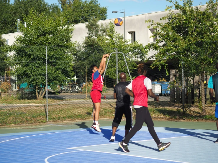 a group of young men playing basketball on a court