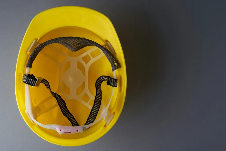 the yellow plastic helmet has wires attached to it