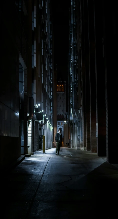people walking down a city street at night