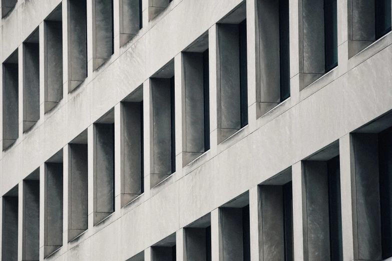 a clock sits on a ledge above some concrete