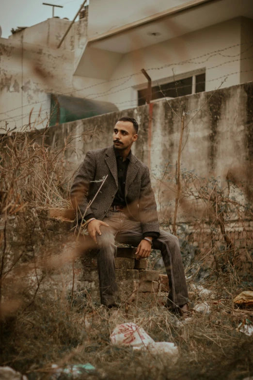 a man sitting outside in the grass