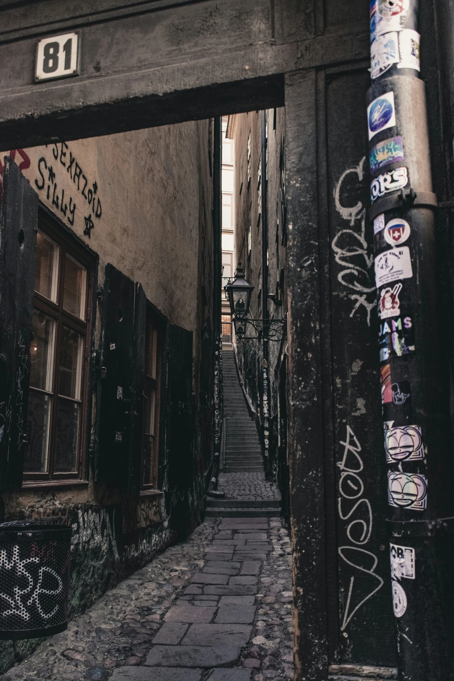 an alleyway with graffiti in the city center