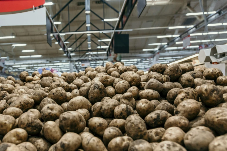 potatoes piled on top of each other in a store