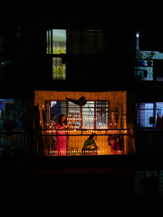 a couple of people sitting on a balcony watching tv