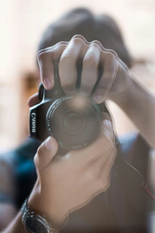 the camera is being held up by the person who is holding a cellphone