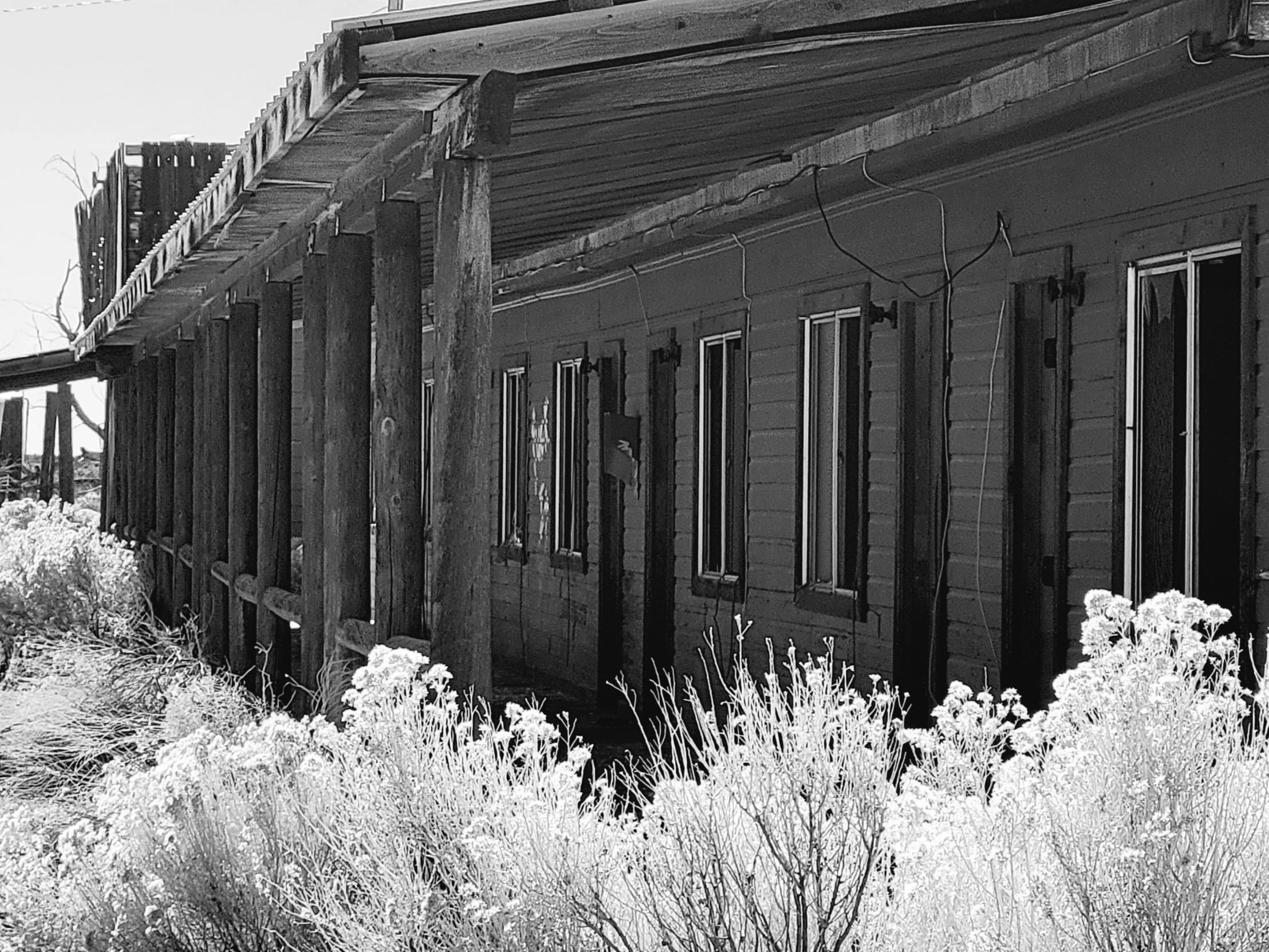 old building in the field next to railroad