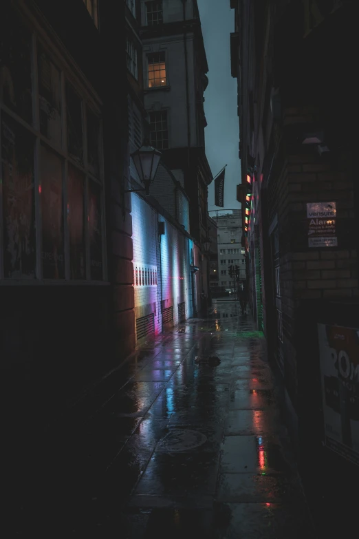 a rainy night on a small city street with rain