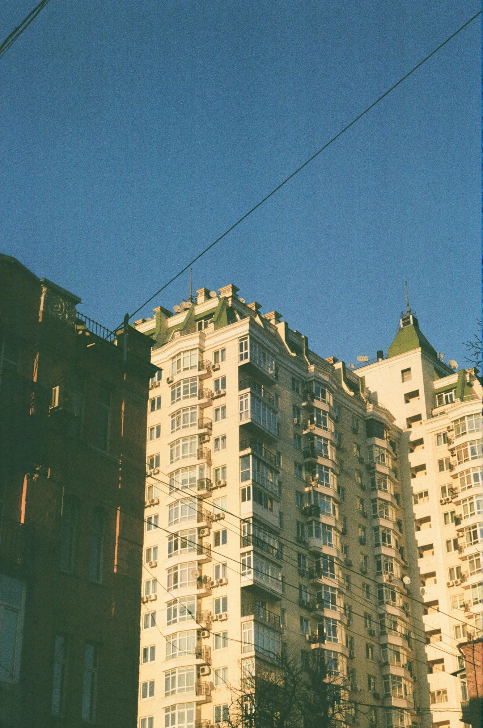 a large apartment building in front of a sky
