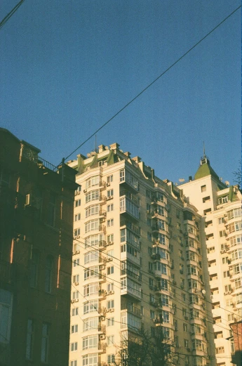 a large apartment building in front of a sky