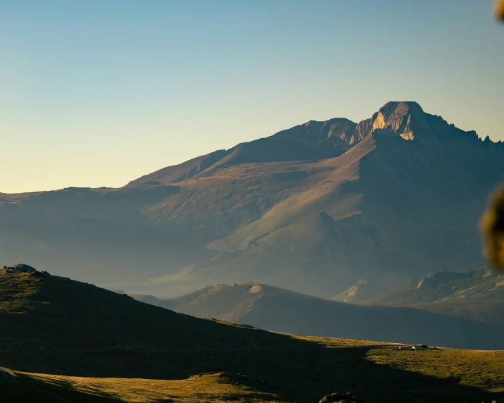 the mountains have snow on them at sunrise