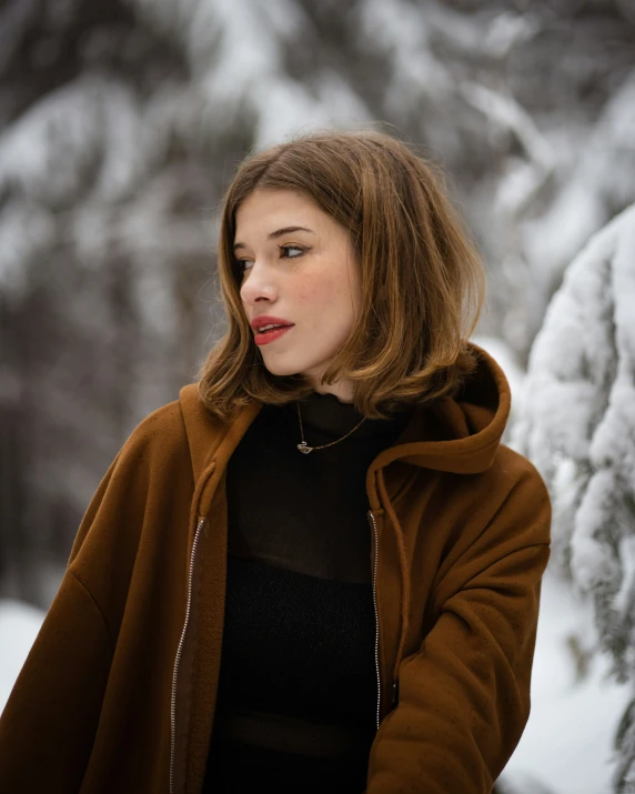 a young lady with long hair standing in the snow