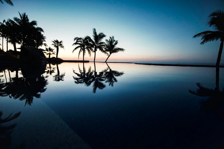 a reflection of a pool in the evening