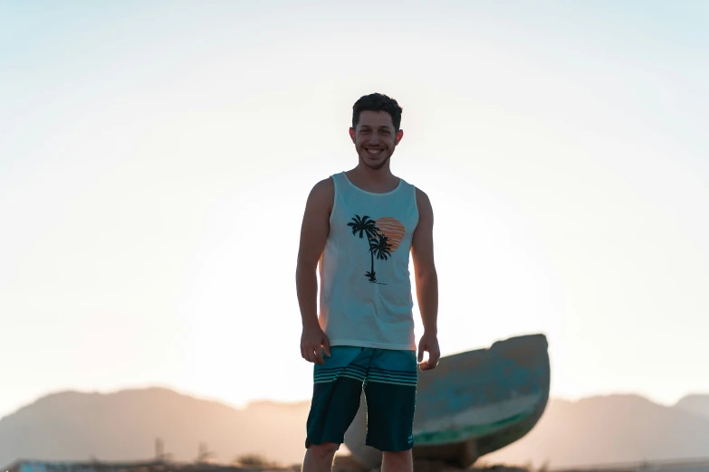 a man in white shirt standing on surfboard at beach