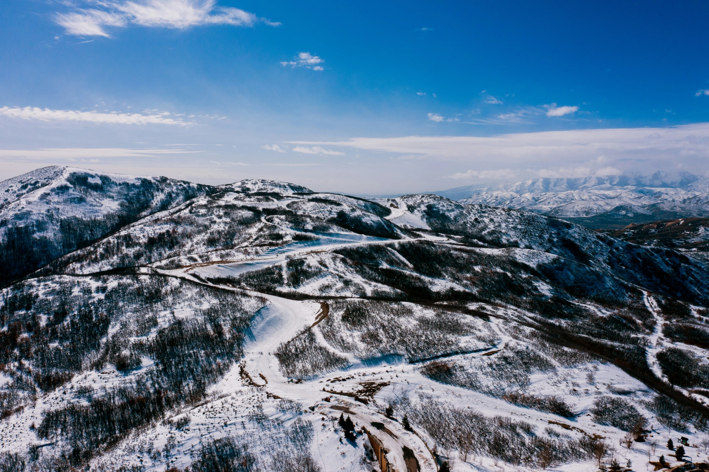 a snow covered mountain top with a snowy landscape