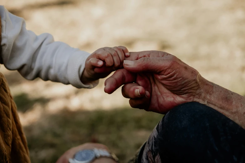 a couple of people are holding hands