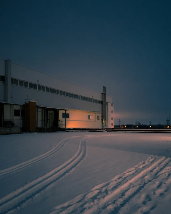 two tracks in the snow next to the building