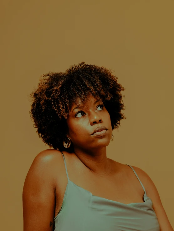 a woman looks upward while posing in her bathing suit