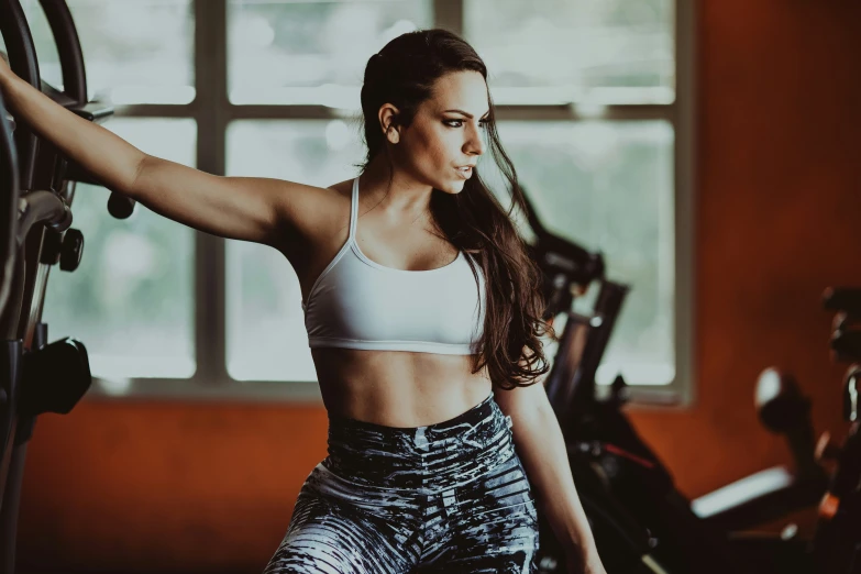 there is a young woman working out on a exercise bike