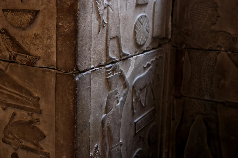 carvings in a wall with black stone carving