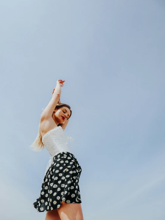 a girl flying in the air with her hand in the air