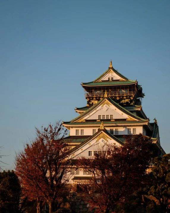 an old building surrounded by trees and fall leaves