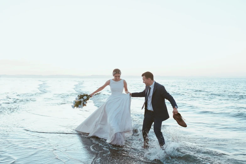 a newly married couple on the ocean shore