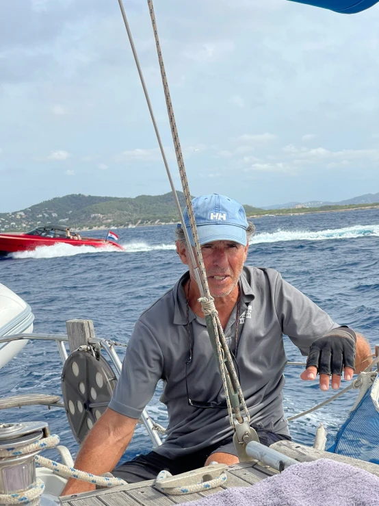 a man with blue cap sitting on a boat