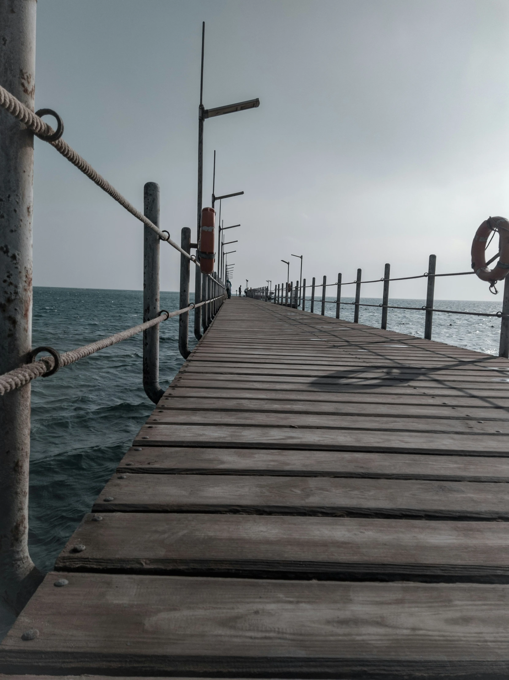 a dock has ropes tied on it near the water